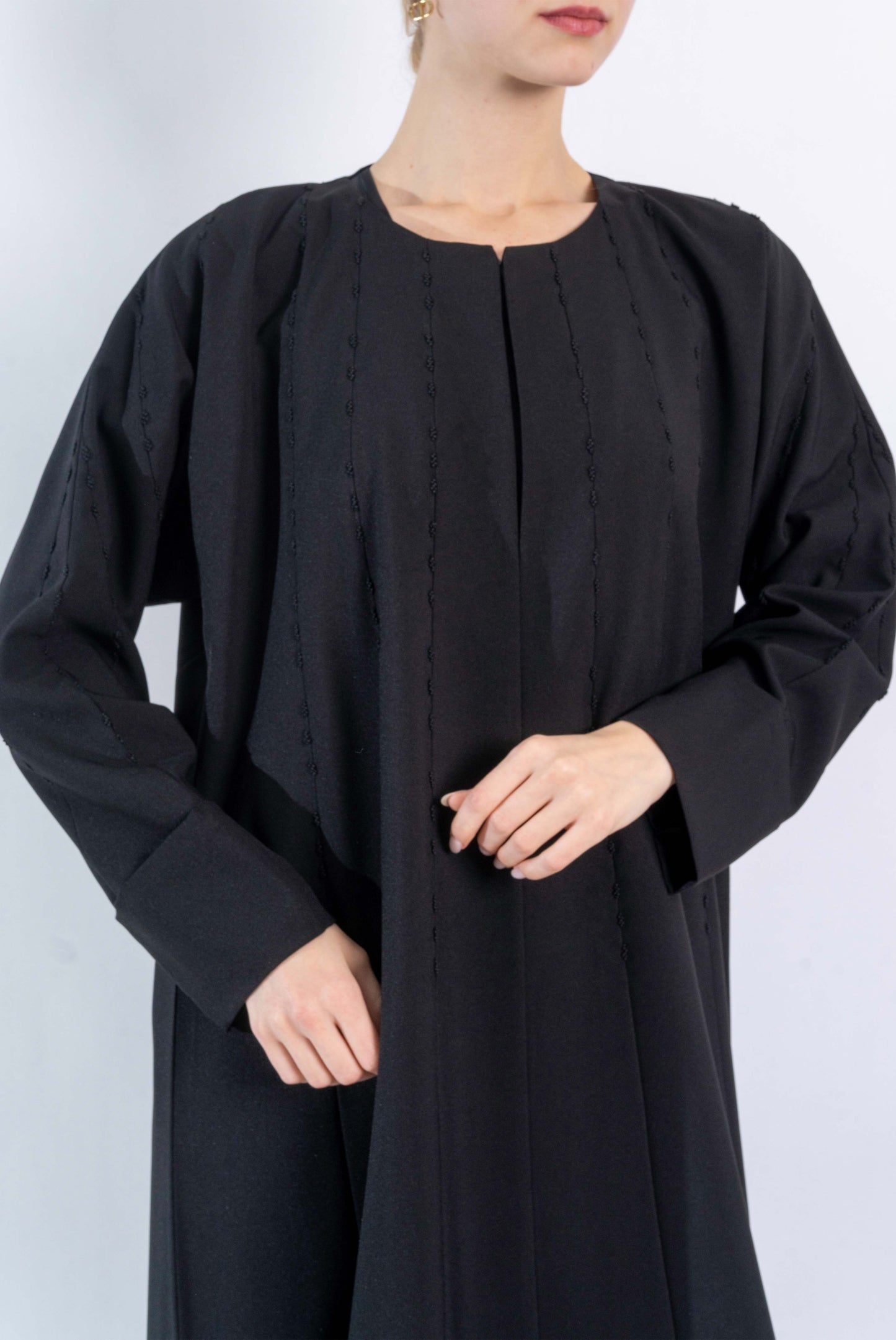 Black Abaya with embroidered pattern.